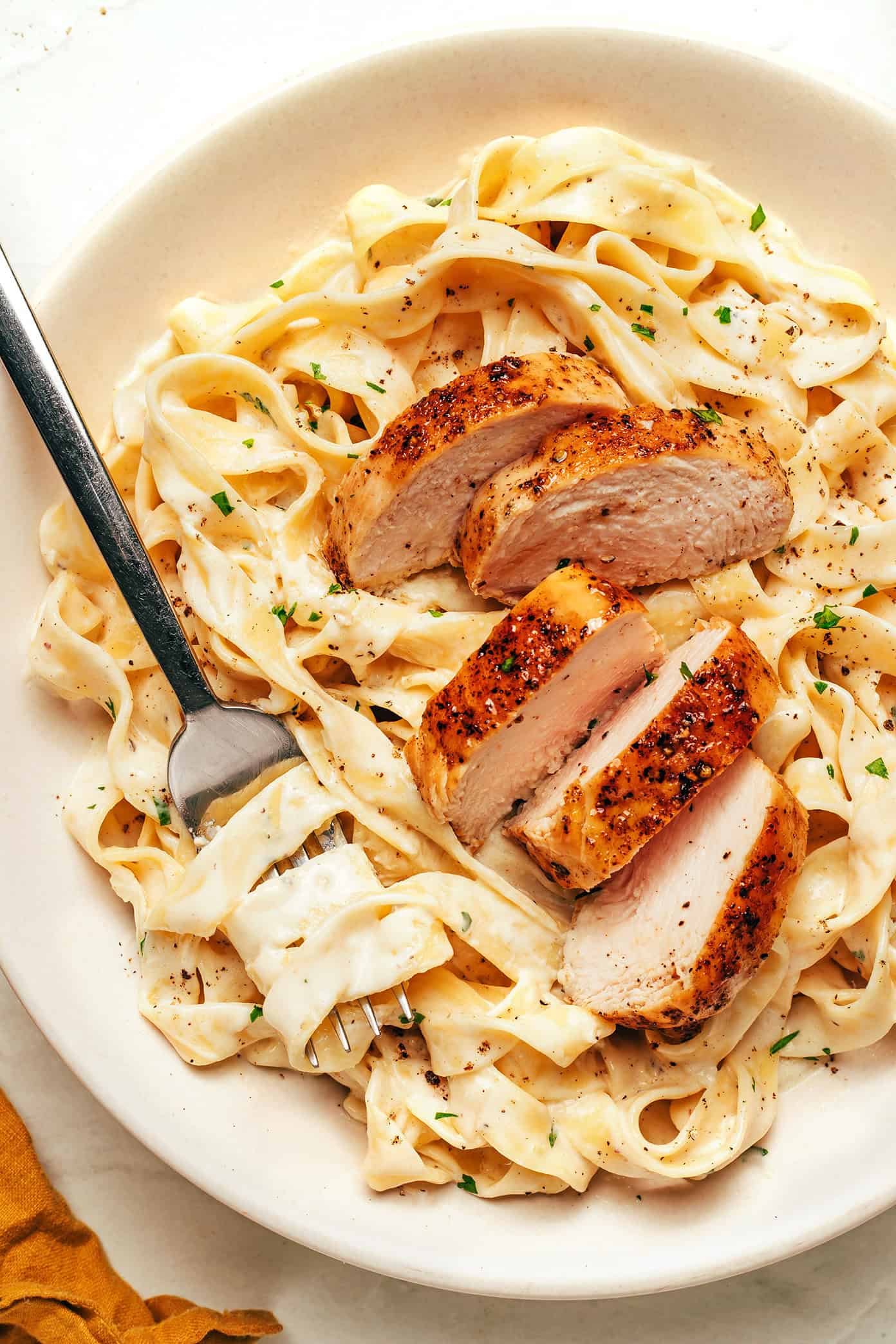 Authentic Fettuccine Alfredo made with fresh fettuccine, butter, Parmigiano Reggiano, and starchy pasta water.