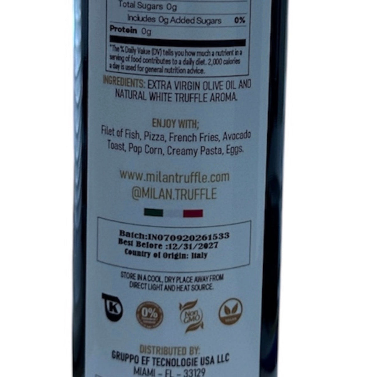 Back label of Milan Truffle white truffle infused extra virgin olive oil showing the ingredient declaration: extra virgin olive oil and natural white truffle aroma