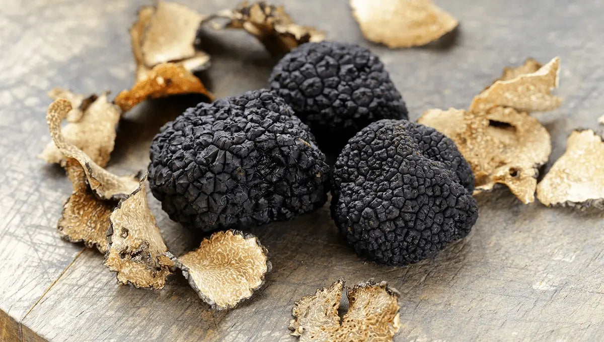 Black truffles on a wooden surface