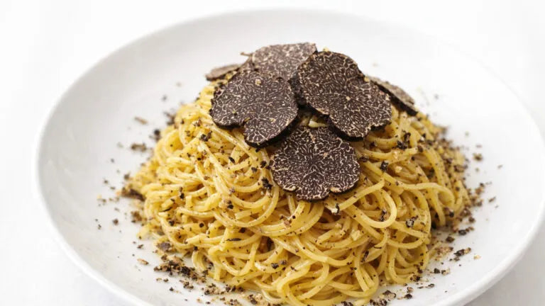 Fresh tagliolini with black truffle Tuber melanosporum and Parmigiano Reggiano