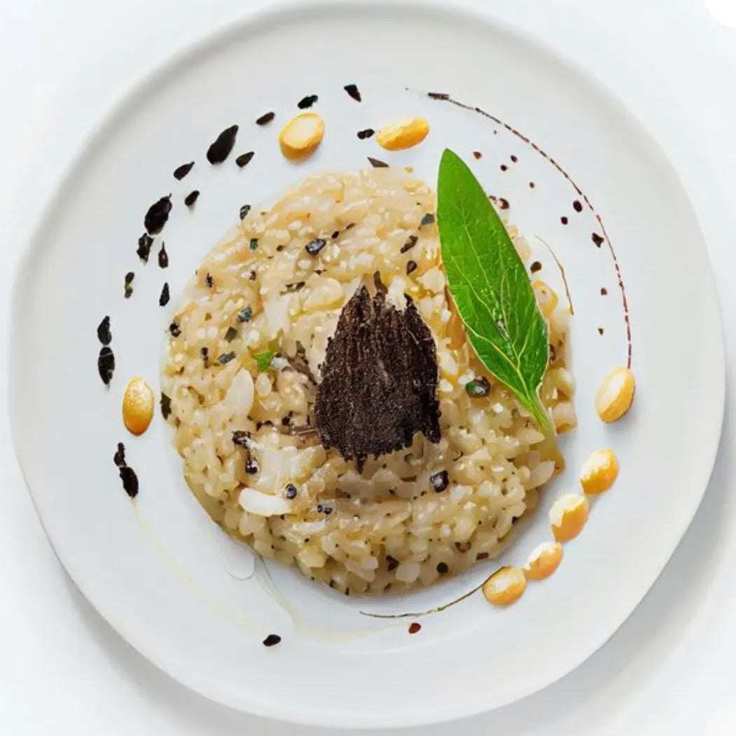 Black truffle risotto with shaved truffle and olive oil, plated in fine dining style on white plate