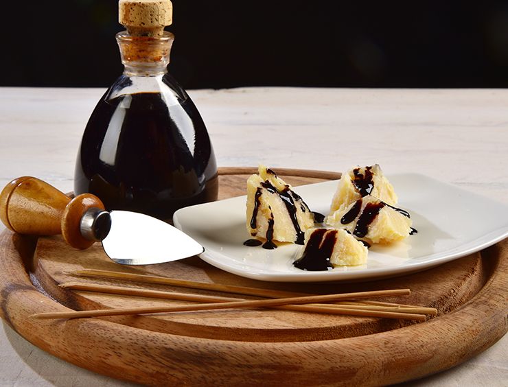 Parmigiano Reggiano pieces drizzled with truffle balsamic condiment