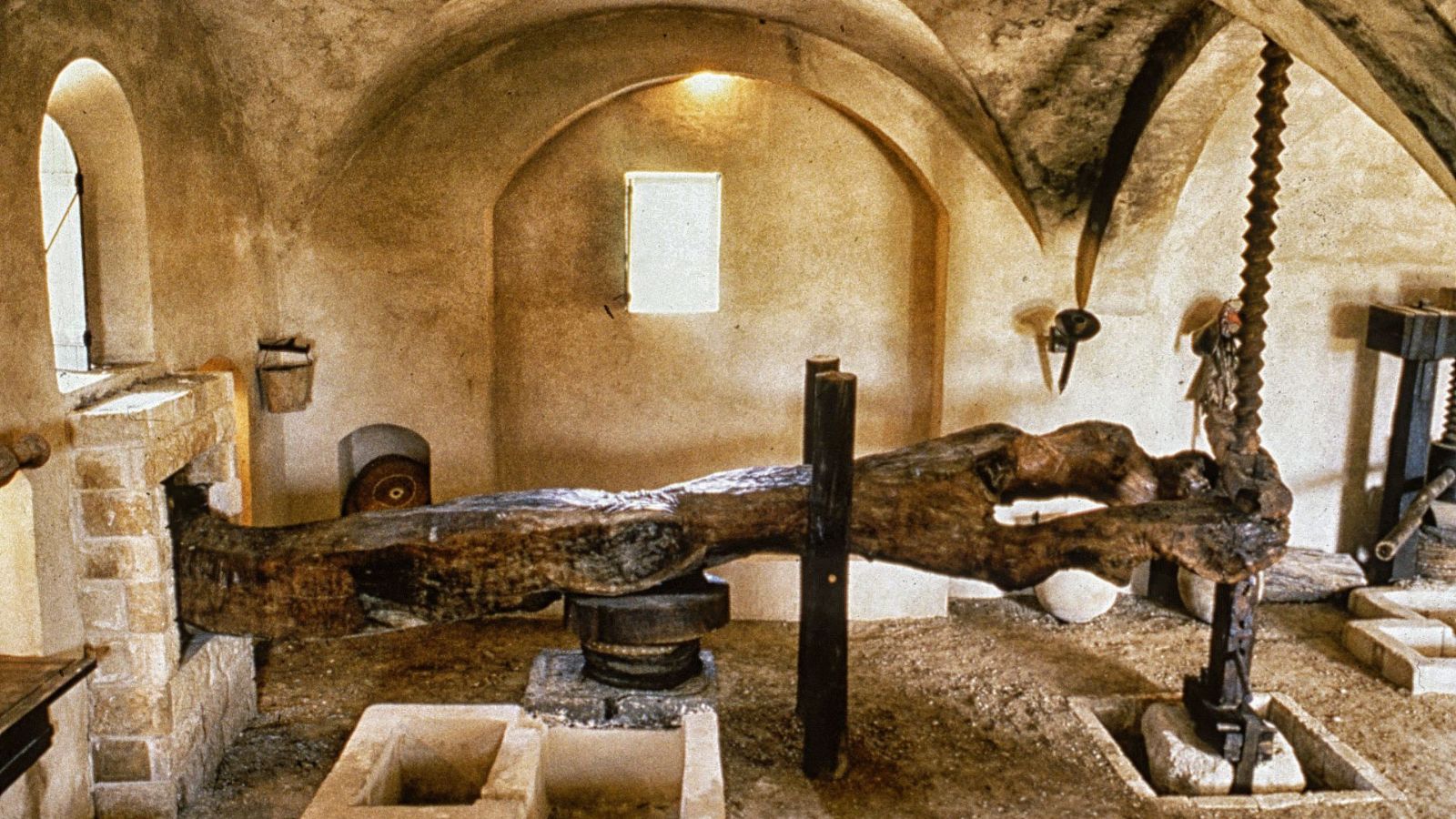 Ancient Mediterranean olive oil press used for large-scale oil production and material processing systems