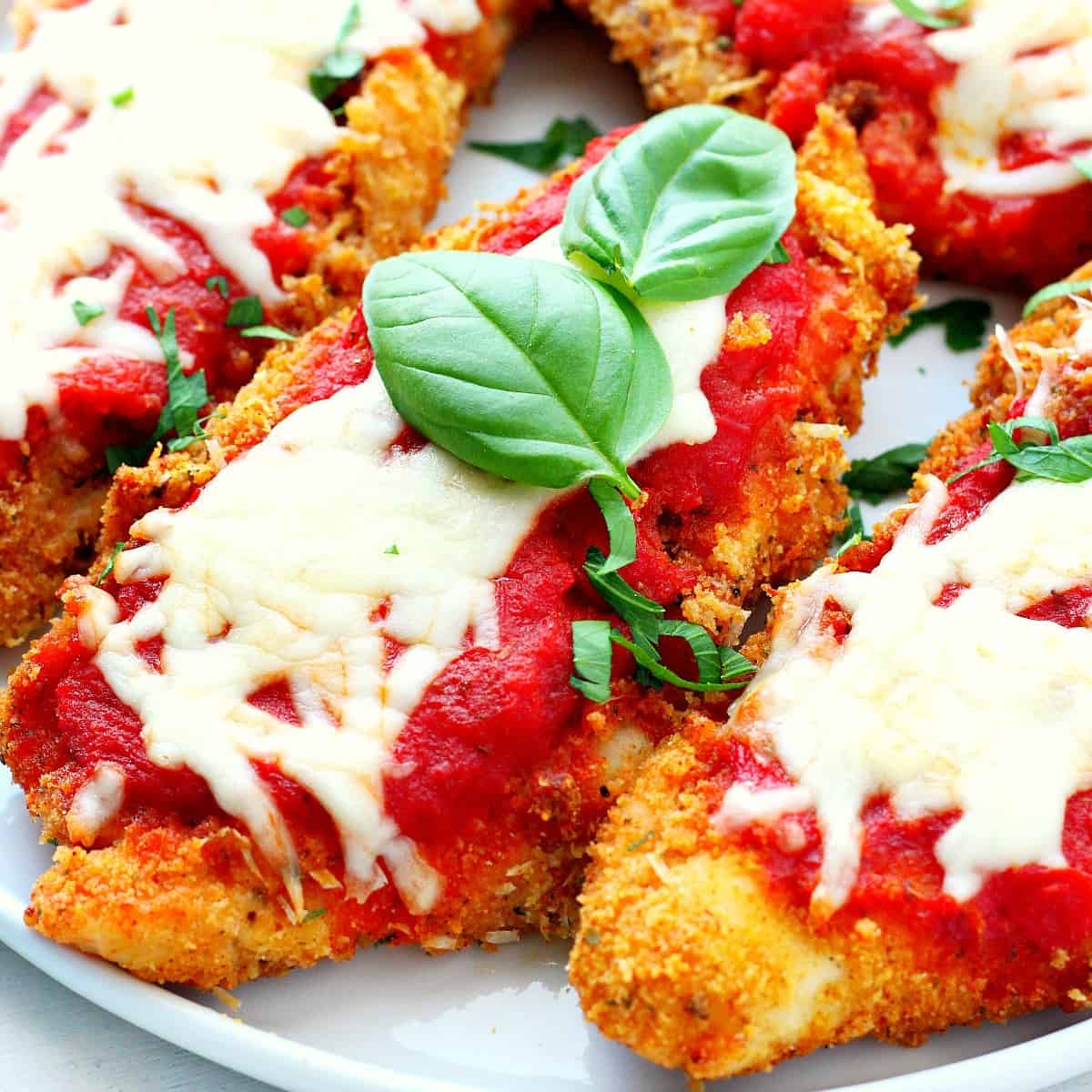 Crispy Chicken Parmesan topped with marinara sauce, melted mozzarella, Parmigiano Reggiano, and fresh basil.