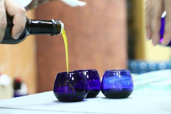 Extra virgin olive oil in a blue tasting glass