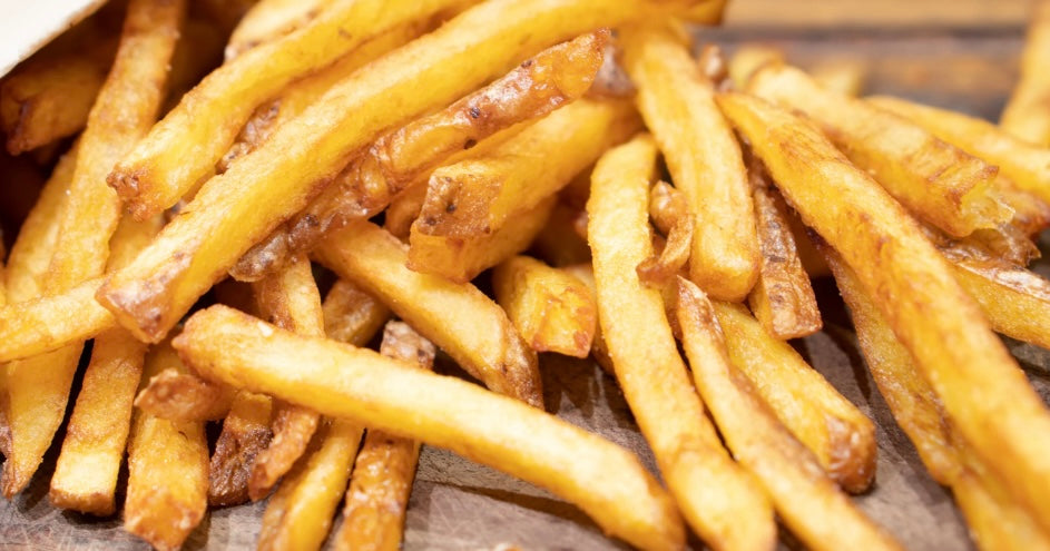 Crispy double-fried truffle fries finished with black truffle oil and Parmigiano Reggiano — Italian technique