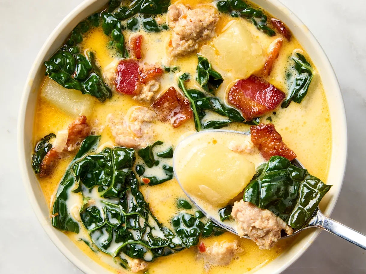 Zuppa Toscana recipe made with Italian sausage, potatoes, kale, crispy bacon, and a creamy broth served in a white bowl.