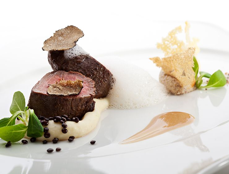 Sliced veal with shaved black truffle and pan sauce