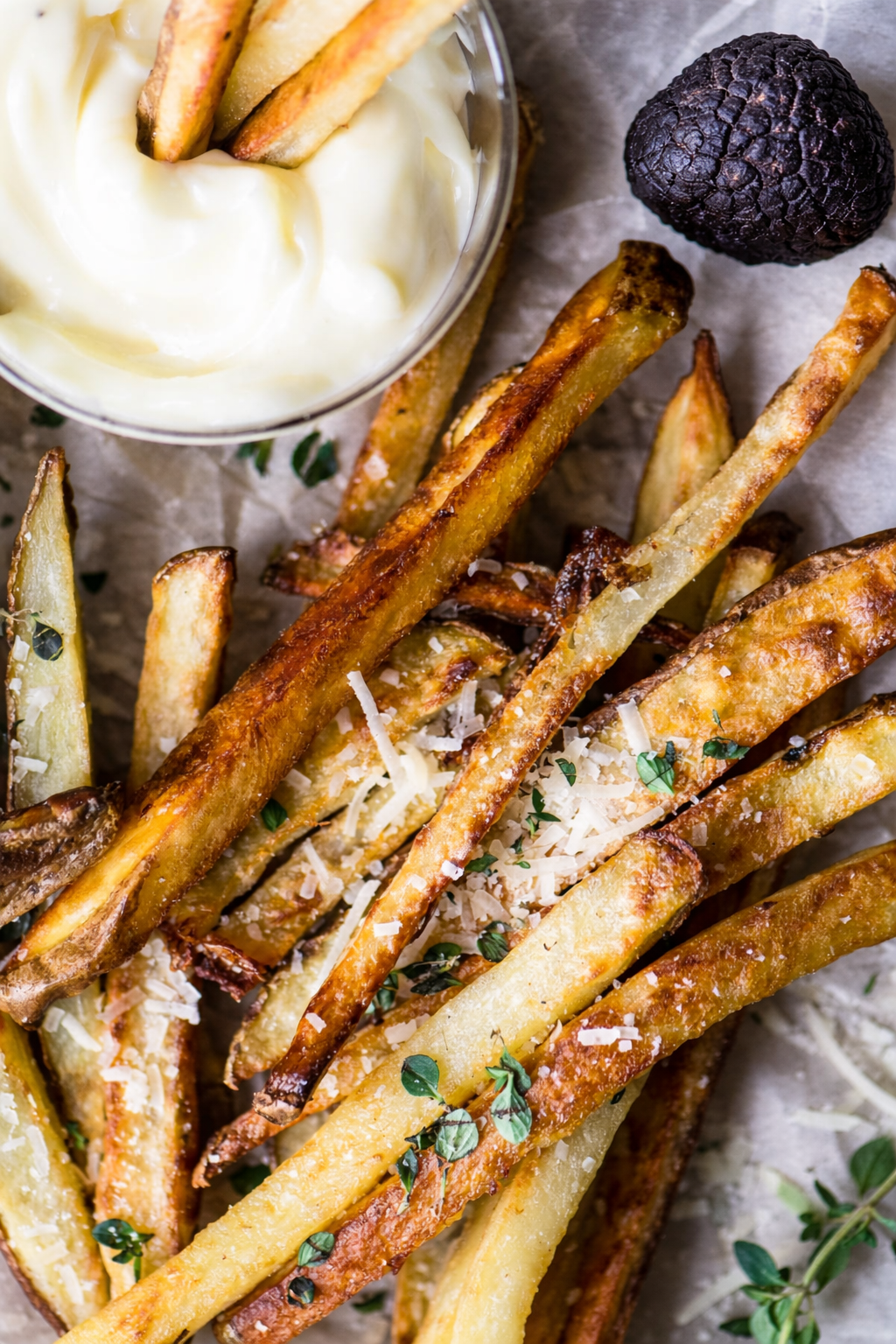 French fries drizzled with black truffle extra virgin olive oil, styled in a gourmet presentation
