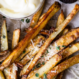 French fries drizzled with black truffle extra virgin olive oil, styled in a gourmet presentation
