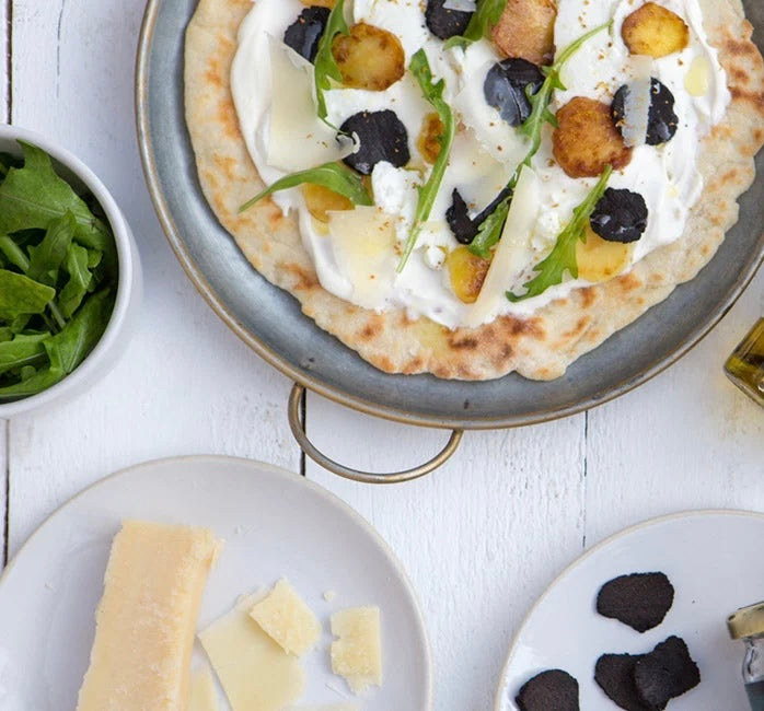 Black truffle pizza with shaved truffle and Vegan Certified truffle olive oil