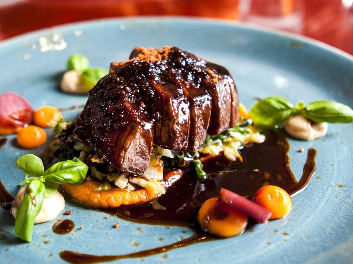 Italian beef tagliata with balsamic vinegar, vegetables, and fresh basil
