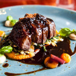 Italian beef tagliata with balsamic vinegar, vegetables, and fresh basil