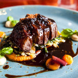 Italian beef tagliata with balsamic vinegar, vegetables, and fresh basil