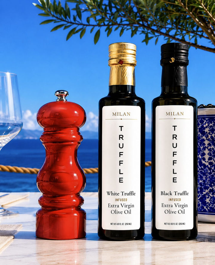 Milan Truffle White and Black Truffle Infused Extra Virgin Olive Oil on a Mediterranean outdoor table with a Ferrari red pepper mill and Sicilian lemons.